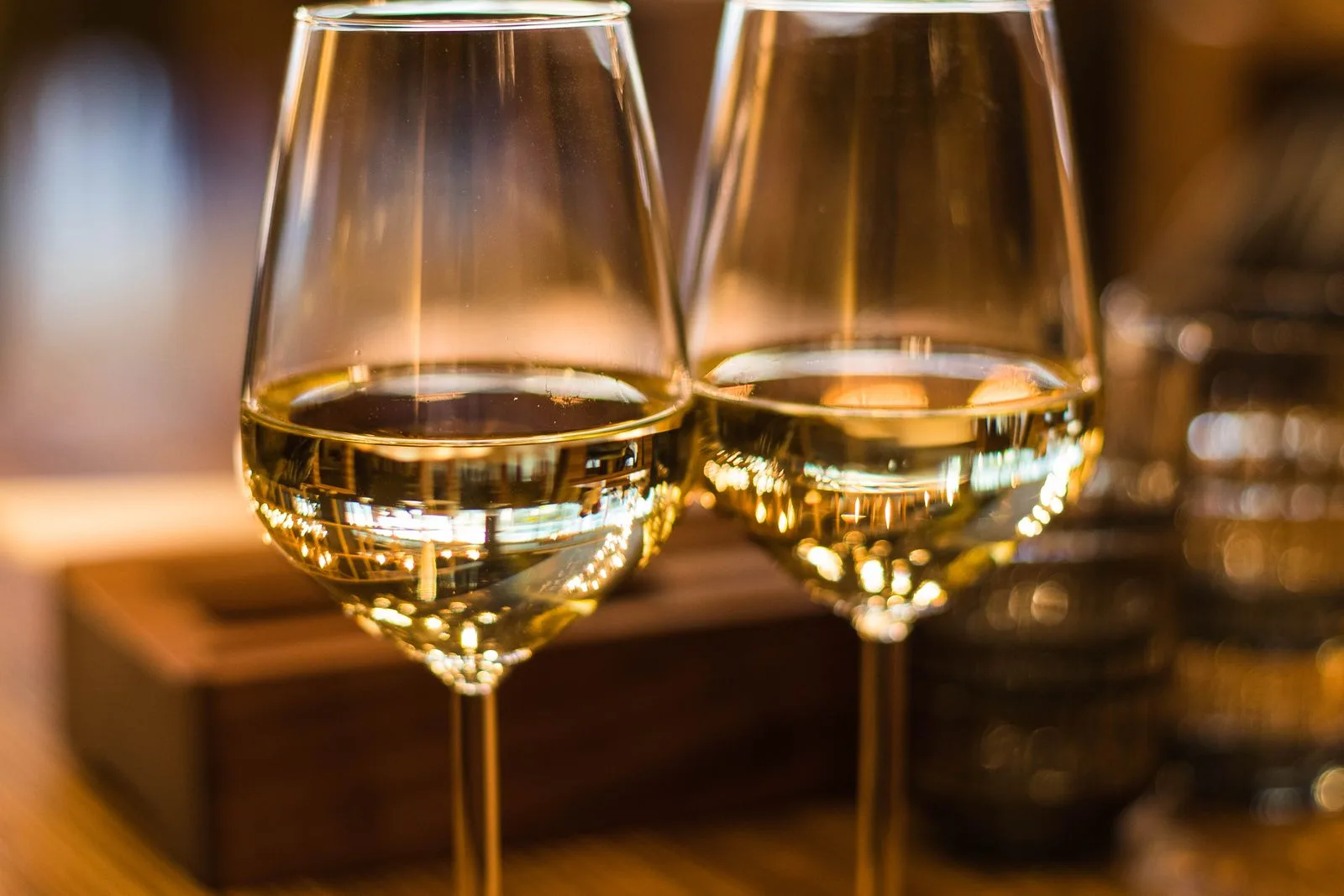 Two glasses in warm candlelight